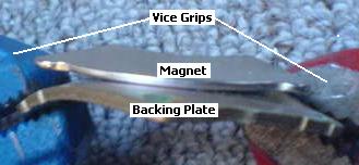 Bending the backing plate away from the magnet