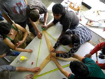 Putting together wooden wind turbine blades at a V3 Power workshop