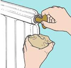 Bleeding a radiator by hand using a radiator key