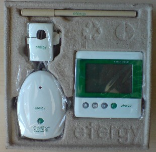 Efergy in its packaging - display unit, sensor, wireless transmitter, and ball-point pen