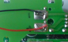 Positive and negative leads soldered to the battery bay contacts