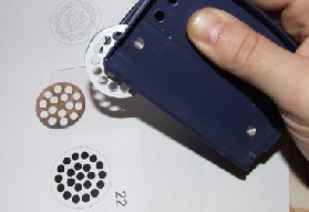 Punch the aluminium sheet with a hole-punch